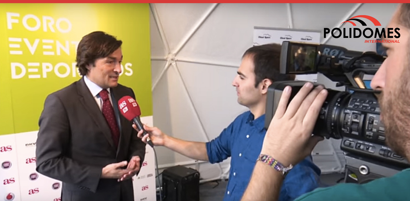 organizer giving an interview in geodesic event tent